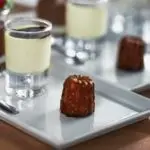 French cake cannele on a plate and vanilla cream